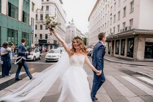 Urban wedding - bride and groom walking on street